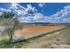Large horse riding arena with white fencing, open field, and mountain views at 810 N Perry Park Rd, Sedalia, CO 80135