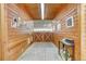 Stables with wood walls, concrete floors, and a wooden gate at the end at 810 N Perry Park Rd, Sedalia, CO 80135