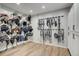Spacious tack room with wooden floor, saddle racks, and bridle hangers at 810 N Perry Park Rd, Sedalia, CO 80135