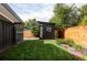 Lush backyard with a modern workspace, surrounded by greenery and a well-maintained lawn at 2525 S Meade St, Denver, CO 80219