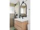 Modern bathroom featuring a wood vanity, black hardware, and a walk-in shower at 2525 S Meade St, Denver, CO 80219