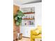 Charming built-in shelves display glassware and books, complemented by a vibrant fig tree and warm lighting at 2525 S Meade St, Denver, CO 80219