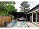 Spacious carport with a sleek car, surrounded by a stylish patio and landscaped yard at 2525 S Meade St, Denver, CO 80219
