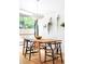 Bright dining area featuring hardwood floors, a stylish light fixture, and large windows at 2525 S Meade St, Denver, CO 80219