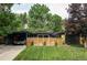 Charming single-story home with a modern design, landscaped front yard, and a covered carport at 2525 S Meade St, Denver, CO 80219