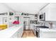 Spacious kitchen with stainless steel appliances, island, and wood flooring at 2525 S Meade St, Denver, CO 80219
