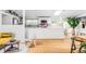 Open-concept kitchen with sleek white cabinetry, modern appliances, and ample counter space at 2525 S Meade St, Denver, CO 80219