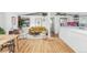 Sun-filled living room featuring hardwood floors, modern furniture, and an open layout to the kitchen at 2525 S Meade St, Denver, CO 80219