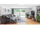 Cozy living room with a large sliding glass door with access to the backyard and a comfortable sectional sofa at 2525 S Meade St, Denver, CO 80219