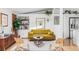 Cozy living room with a comfortable yellow sofa, hardwood floors, and stylish decor at 2525 S Meade St, Denver, CO 80219