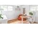 Bright home office with a wooden desk, modern chair, and ample natural light from the surrounding windows at 2525 S Meade St, Denver, CO 80219