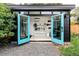 Modern backyard office with open doors, showcasing a clean interior with shelving and a workspace at 2525 S Meade St, Denver, CO 80219