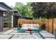 Cozy outdoor patio space with stylish seating, modern pavers, and a fenced perimeter for privacy at 2525 S Meade St, Denver, CO 80219