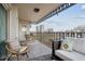 A comfortable outdoor balcony seating area boasts city views and includes wicker chairs and a lounge space at 1223 Race St # 605, Denver, CO 80206
