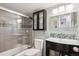 Elegant bathroom with tiled shower/tub, modern vanity, and stylish mirror at 1223 Race St # 605, Denver, CO 80206