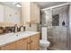 Modern bathroom features a glass-enclosed shower, granite counters and custom vanity at 1223 Race St # 605, Denver, CO 80206
