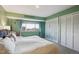 Bright bedroom featuring large window with neighborhood views and double closets at 1223 Race St # 605, Denver, CO 80206