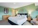 Comfortable bedroom with green walls, soft carpet, and tasteful decor at 1223 Race St # 605, Denver, CO 80206
