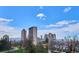 View of the Denver skyline and trees with a brilliant blue sky at 1223 Race St # 605, Denver, CO 80206