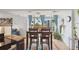 Bright dining area with views from large windows featuring a dining table and adjacent kitchen at 1223 Race St # 605, Denver, CO 80206