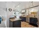 Modern kitchen featuring stainless steel appliances, granite counters, tile backsplash and hardwood floors at 1223 Race St # 605, Denver, CO 80206