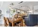 Open kitchen and dining area with stainless appliances, track lighting, and modern cabinetry at 1223 Race St # 605, Denver, CO 80206