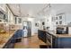 Open kitchen features stainless steel appliances, granite counters, and two-tone cabinetry at 1223 Race St # 605, Denver, CO 80206
