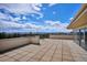 Expansive rooftop patio with tile flooring showcases stunning city and mountain views at 1223 Race St # 605, Denver, CO 80206
