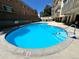 Clean in-ground pool with crystal clear water and ladder entry surrounded by lounge seating at 1223 Race St # 605, Denver, CO 80206