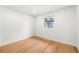 Well-lit bedroom with hardwood floors and a window offering natural light at 9663 Meade Ct, Westminster, CO 80031