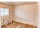 Bedroom featuring wood-look floors, neutral walls, and a window at 1925 S Irving St, Denver, CO 80219