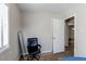 Bedroom featuring wood-look flooring, a window, a leaning mirror, and a black office chair at 1925 S Irving St, Denver, CO 80219