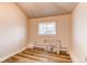 Bedroom featuring wood-look floors, neutral walls, and a window at 1925 S Irving St, Denver, CO 80219
