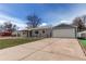 Charming single-story home with a detached two-car garage and long driveway at 1925 S Irving St, Denver, CO 80219