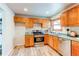 Kitchen showcasing stainless steel appliances, wooden cabinets and a view from the window at 1925 S Irving St, Denver, CO 80219