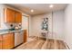Kitchen with wood cabinets, stainless steel dishwasher, and modern recessed lighting at 1925 S Irving St, Denver, CO 80219