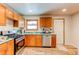 Kitchen with wooden cabinets, stainless steel appliances, and lots of natural light at 1925 S Irving St, Denver, CO 80219