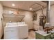 Well-lit laundry room with washer, dryer, and water heater at 1925 S Irving St, Denver, CO 80219