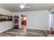 Living room with wood floors, adjacent to the kitchen with stainless steel appliances at 1925 S Irving St, Denver, CO 80219