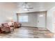 Living room showcasing new floors, a ceiling fan and a large window for great natural light at 1925 S Irving St, Denver, CO 80219