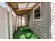 Outdoor covered patio with a translucent roof and artificial grass at 1925 S Irving St, Denver, CO 80219