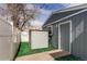 Backyard shed with a gray exterior next to a door that leads to the outside at 1925 S Irving St, Denver, CO 80219