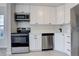 Updated kitchen featuring stainless steel appliances and white shaker cabinets at 155 S Sable Blvd # S26, Aurora, CO 80012