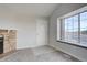 Living room with stone fireplace and large window at 155 S Sable Blvd # S26, Aurora, CO 80012