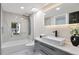 Modern bathroom with marble tile, a soaking tub, and a walk-in shower at 3545 W Custer Pl, Denver, CO 80219