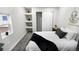 Serene bedroom featuring a cozy bed, built-in shelves, and a window at 3545 W Custer Pl, Denver, CO 80219