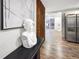 Entryway with modern wood wall and view into living room and kitchen at 3545 W Custer Pl, Denver, CO 80219