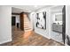 Bright hallway with hardwood floors and view of staircase and bathroom at 3545 W Custer Pl, Denver, CO 80219