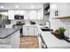 Modern white kitchen with stainless steel appliances at 3545 W Custer Pl, Denver, CO 80219