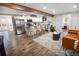 Modern kitchen with island, stainless steel appliances, and hardwood floors at 3545 W Custer Pl, Denver, CO 80219